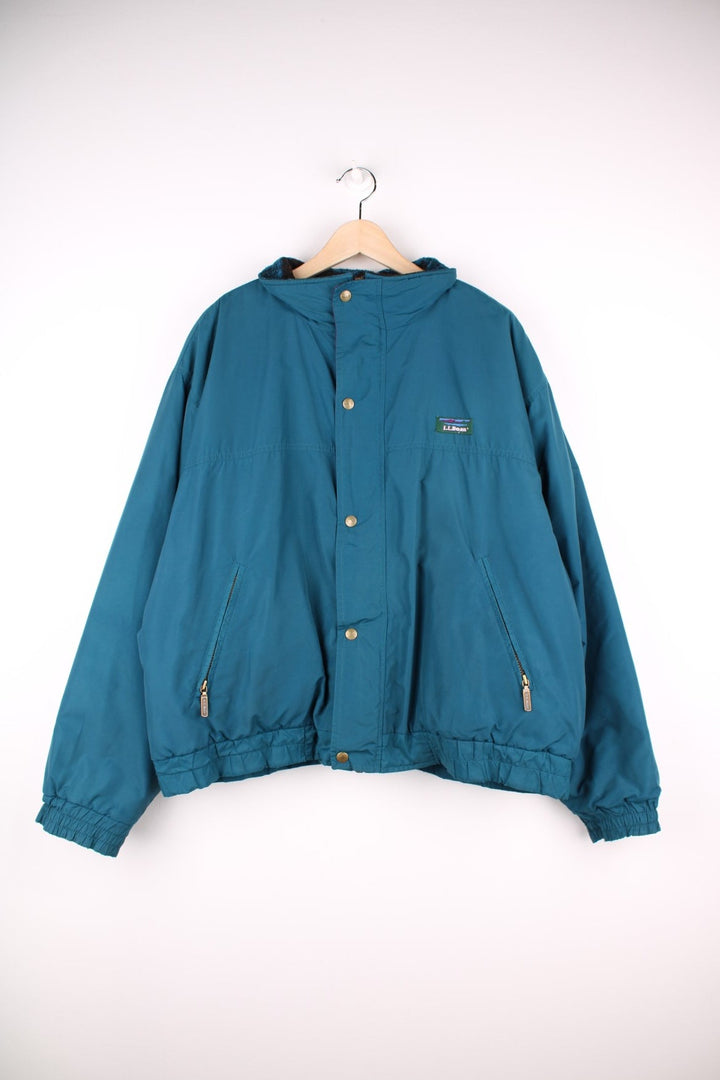 Vintage 90's L.L. Bean Lovell Jacket in a blue colourway, zip and button up, has a patterned fleece lining, side pockets, and the logo embroidered on the front. 