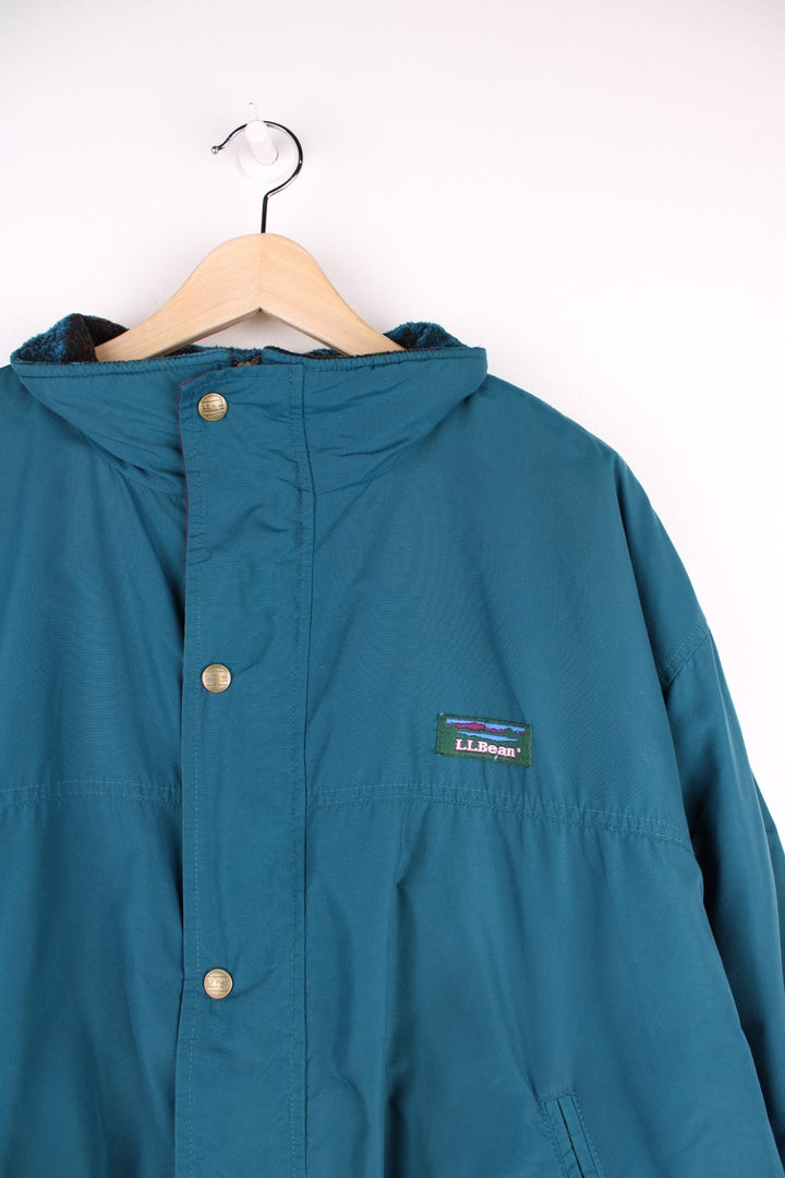 Vintage 90's L.L. Bean Lovell Jacket in a blue colourway, zip and button up, has a patterned fleece lining, side pockets, and the logo embroidered on the front. 