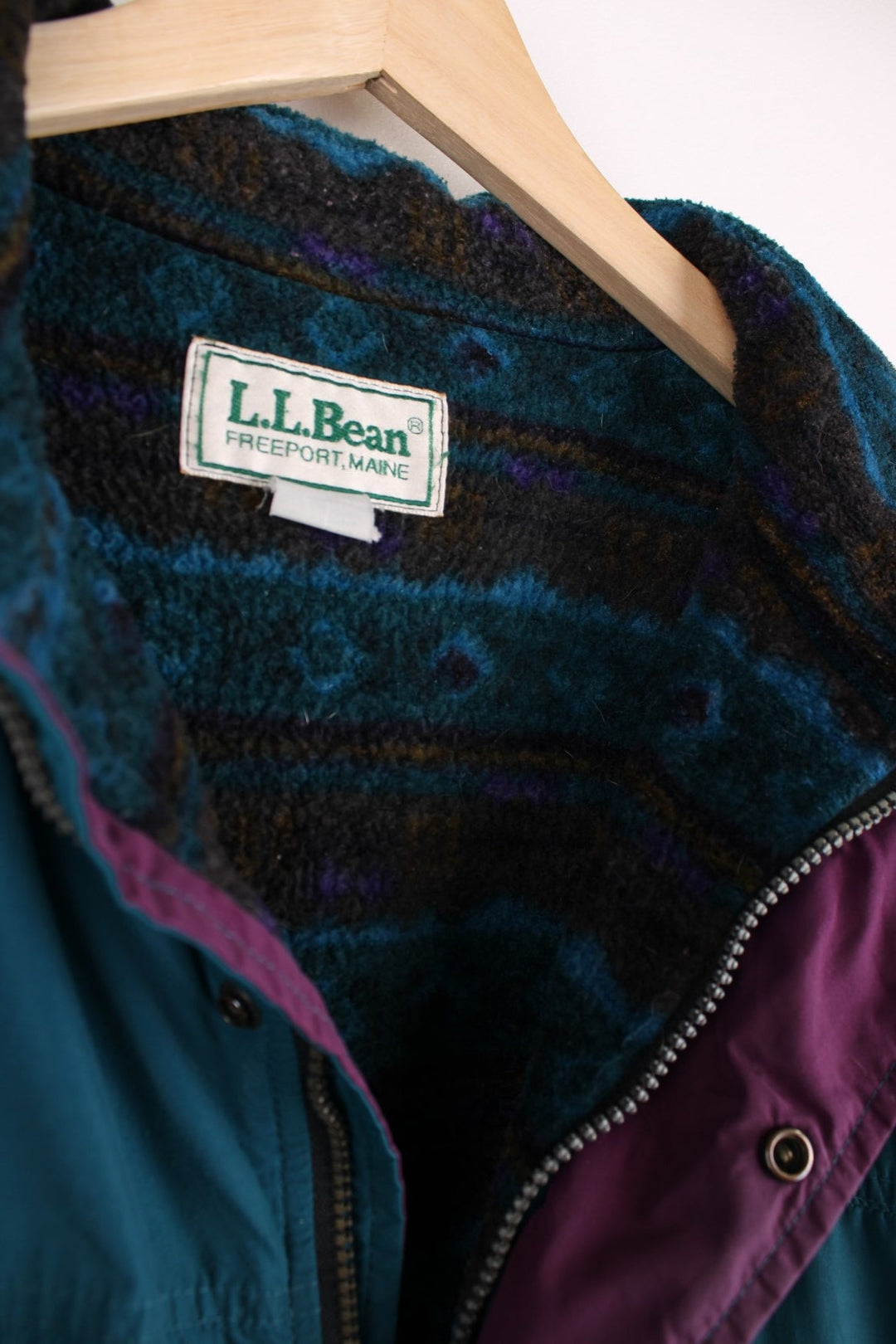 Vintage 90's L.L. Bean Lovell Jacket in a blue colourway, zip and button up, has a patterned fleece lining, side pockets, and the logo embroidered on the front. 