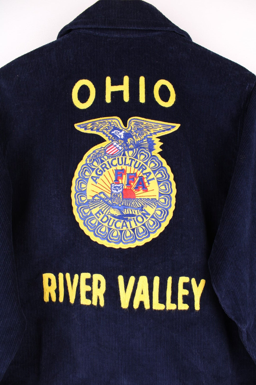 80's FFA Agricultural Education Jacket in blue colourway, zip up with side pockets, v neck dagger collar, and has embroidered logo patches on the front and back. 