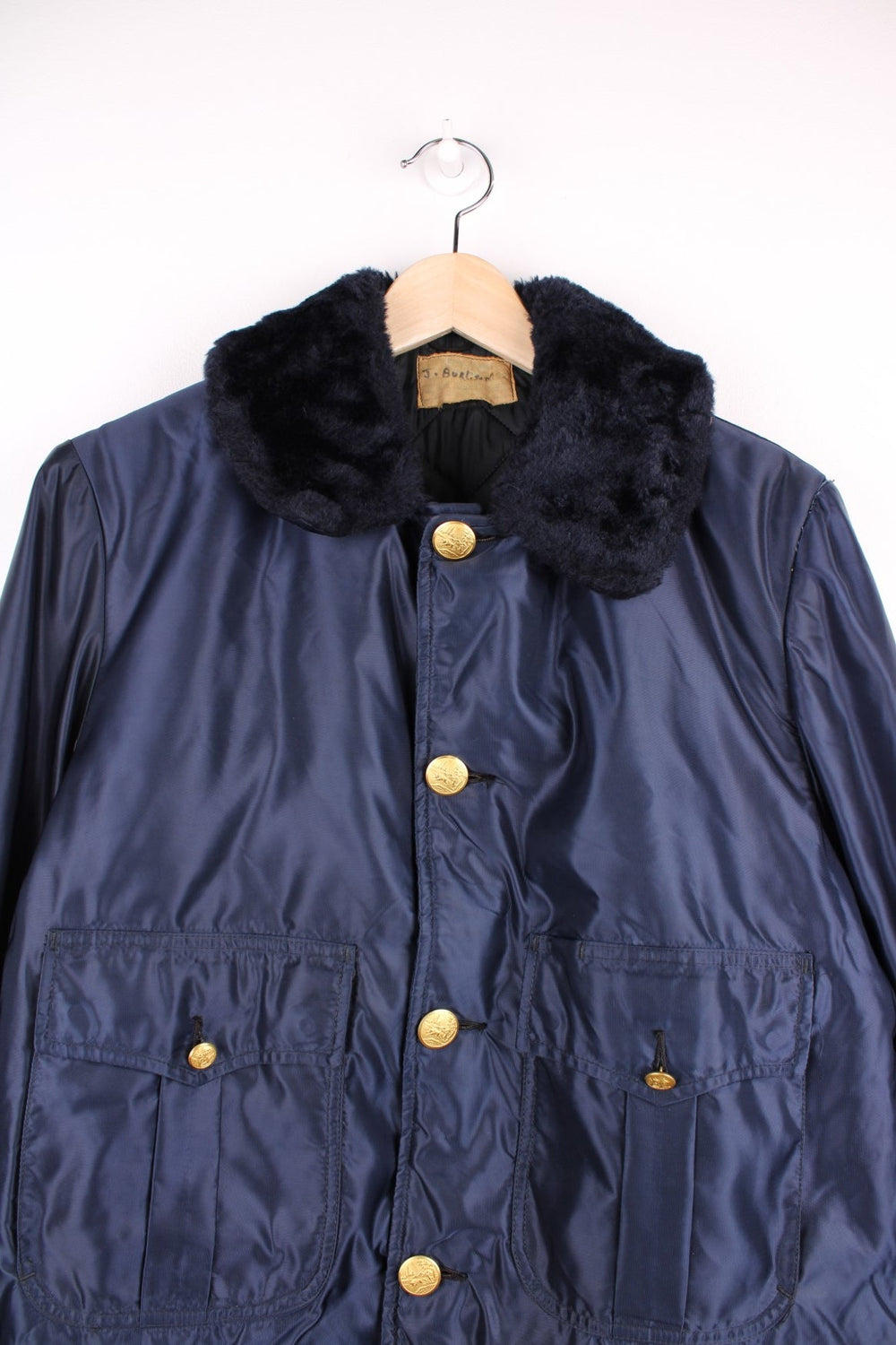 70s Gerber 'Car-Duty' bomber jacket in navy blue - quilt-lined, with a faux fur collar, gold buttons, and four pockets. 