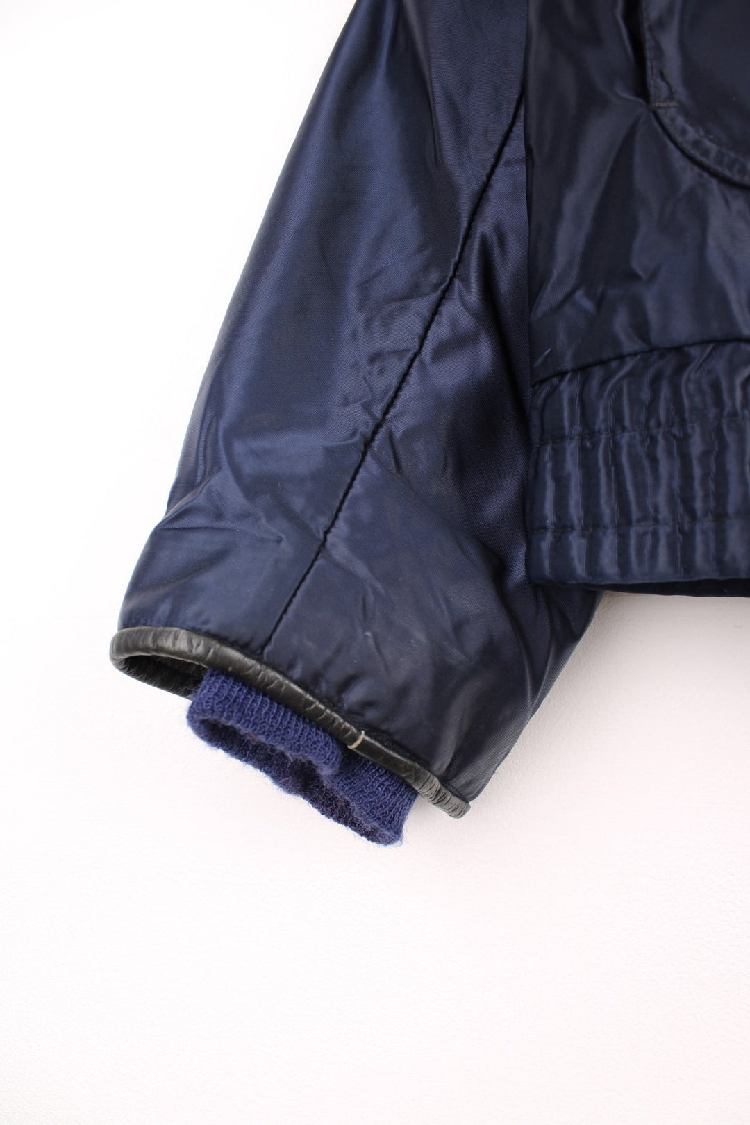 70s Gerber 'Car-Duty' bomber jacket in navy blue - quilt-lined, with a faux fur collar, gold buttons, and four pockets. 