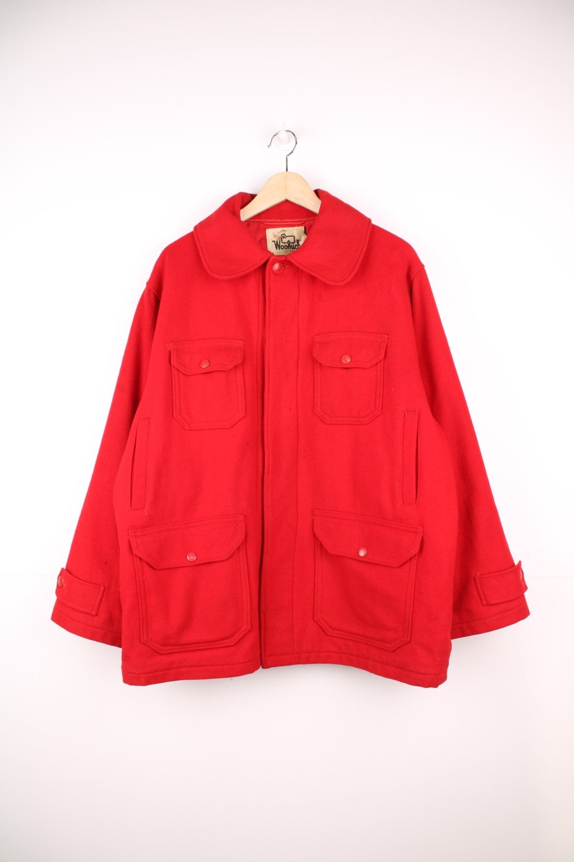 Woolrich red CPO jacket with zip closure and four pockets. Quilt lined with hunting themed pattern inside. 