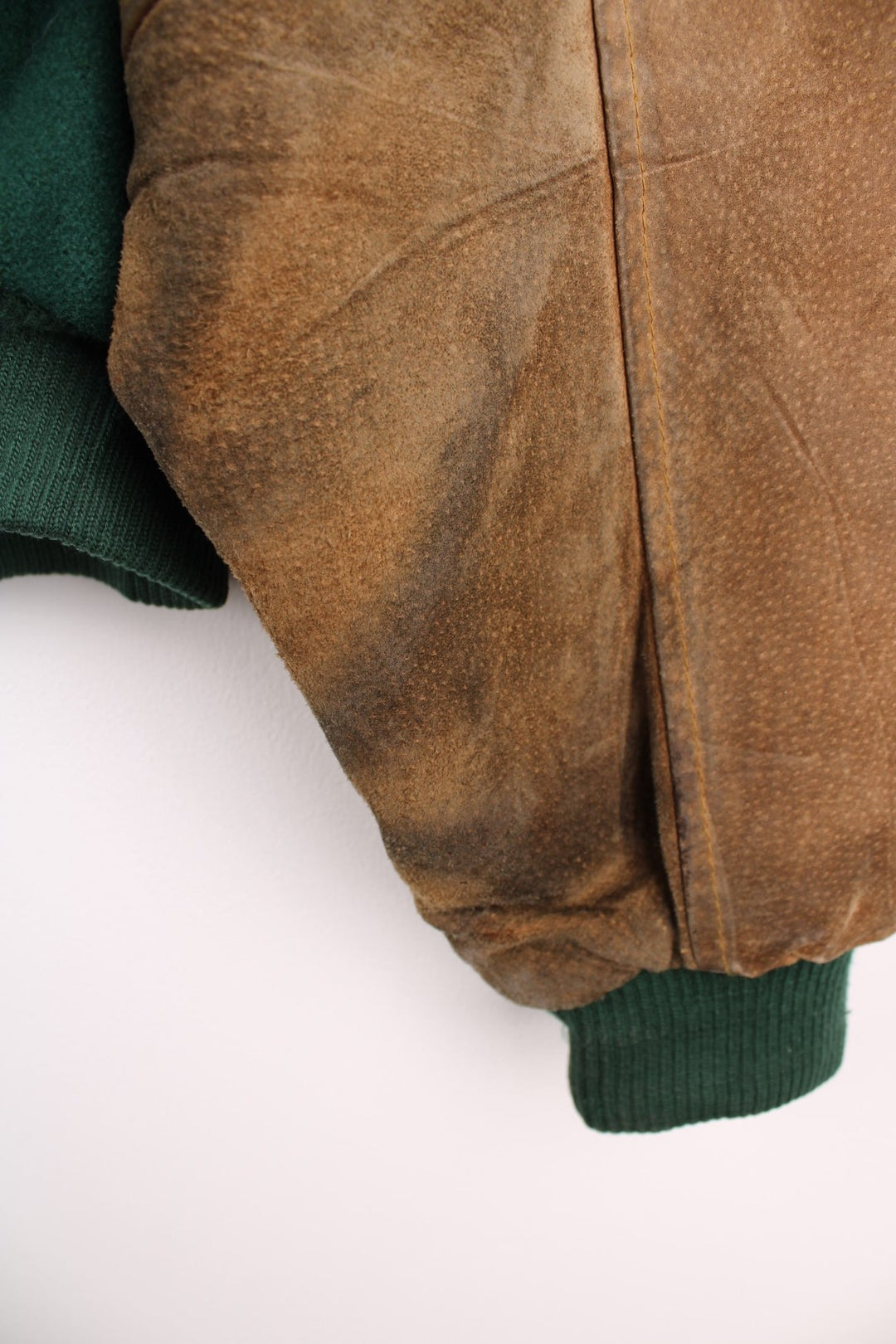 Becks Beer Varsity Jacket in a green and brown colourway, button up and has side pockets, insulated with a quilted lining, and has the logo embroidered on the front.