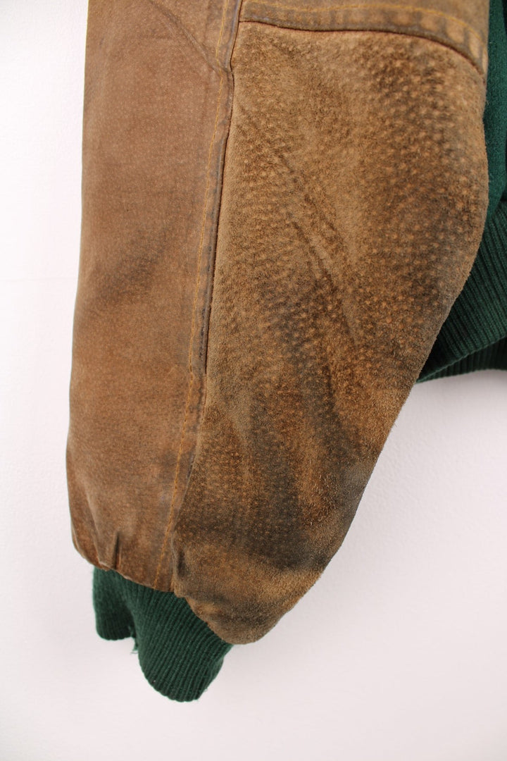 Becks Beer Varsity Jacket in a green and brown colourway, button up and has side pockets, insulated with a quilted lining, and has the logo embroidered on the front.