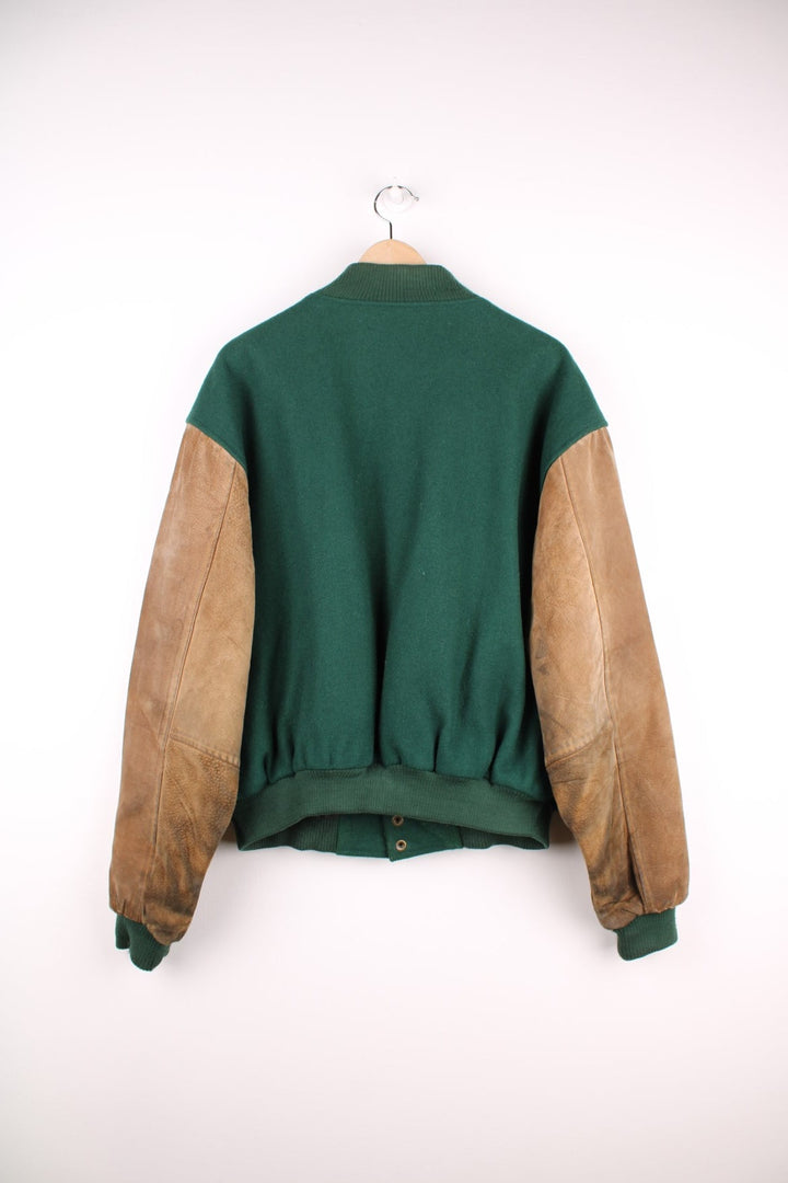 Becks Beer Varsity Jacket in a green and brown colourway, button up and has side pockets, insulated with a quilted lining, and has the logo embroidered on the front.