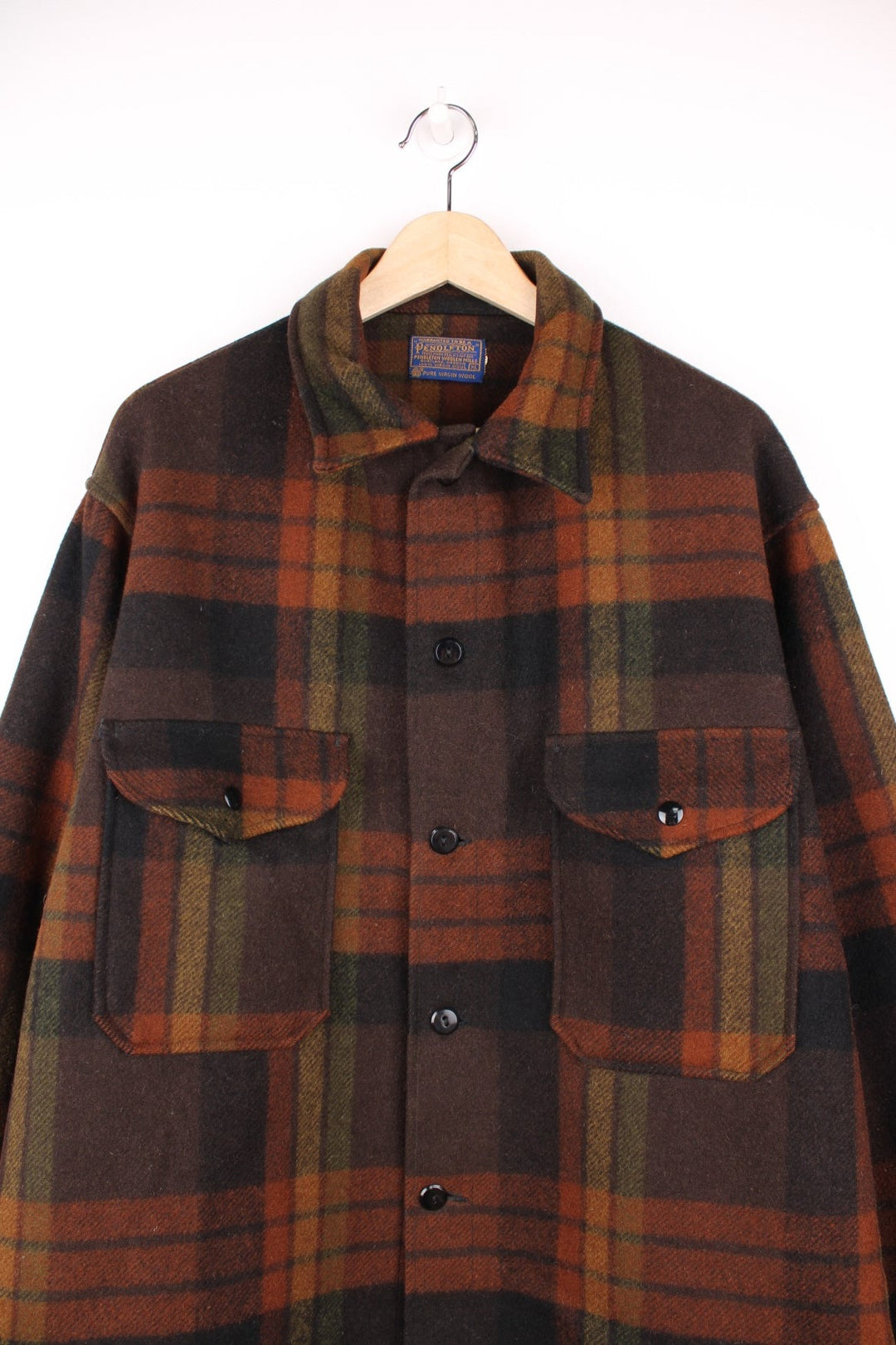 Pendleton brown plaid CPO jacket with two flap pockets and button closure. 