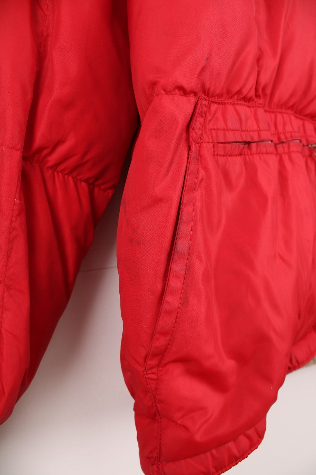 Red Bauer Down hooded puffer jacket with two pockets and zip closure. 