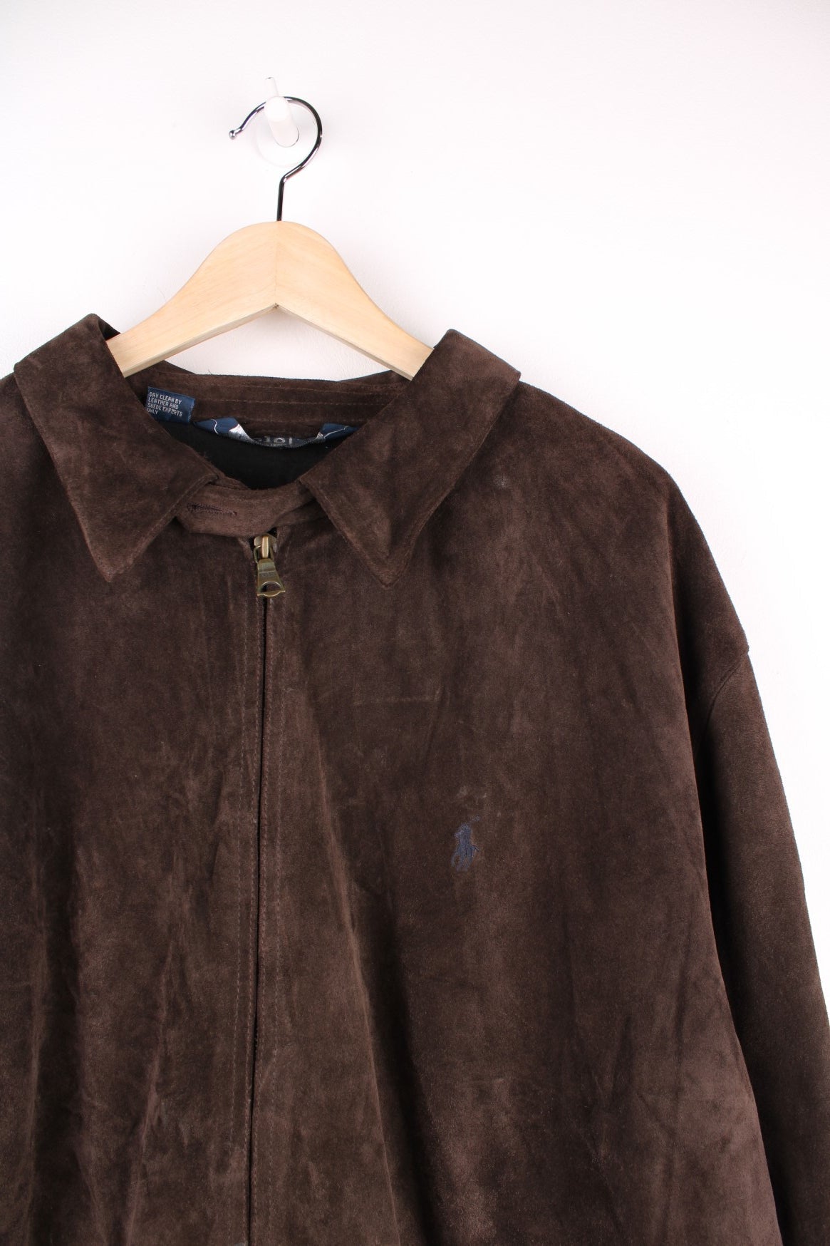 Ralph Lauren Leather Harrington Jacket in a brown colourway, zips up and has side pockets, fleece lining, and the logo embroidered on the chest. 