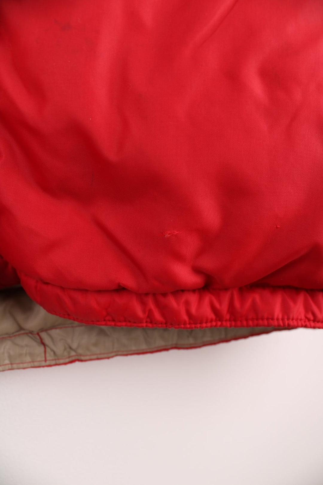 Red Bauer Down hooded puffer jacket with two pockets and zip closure. 