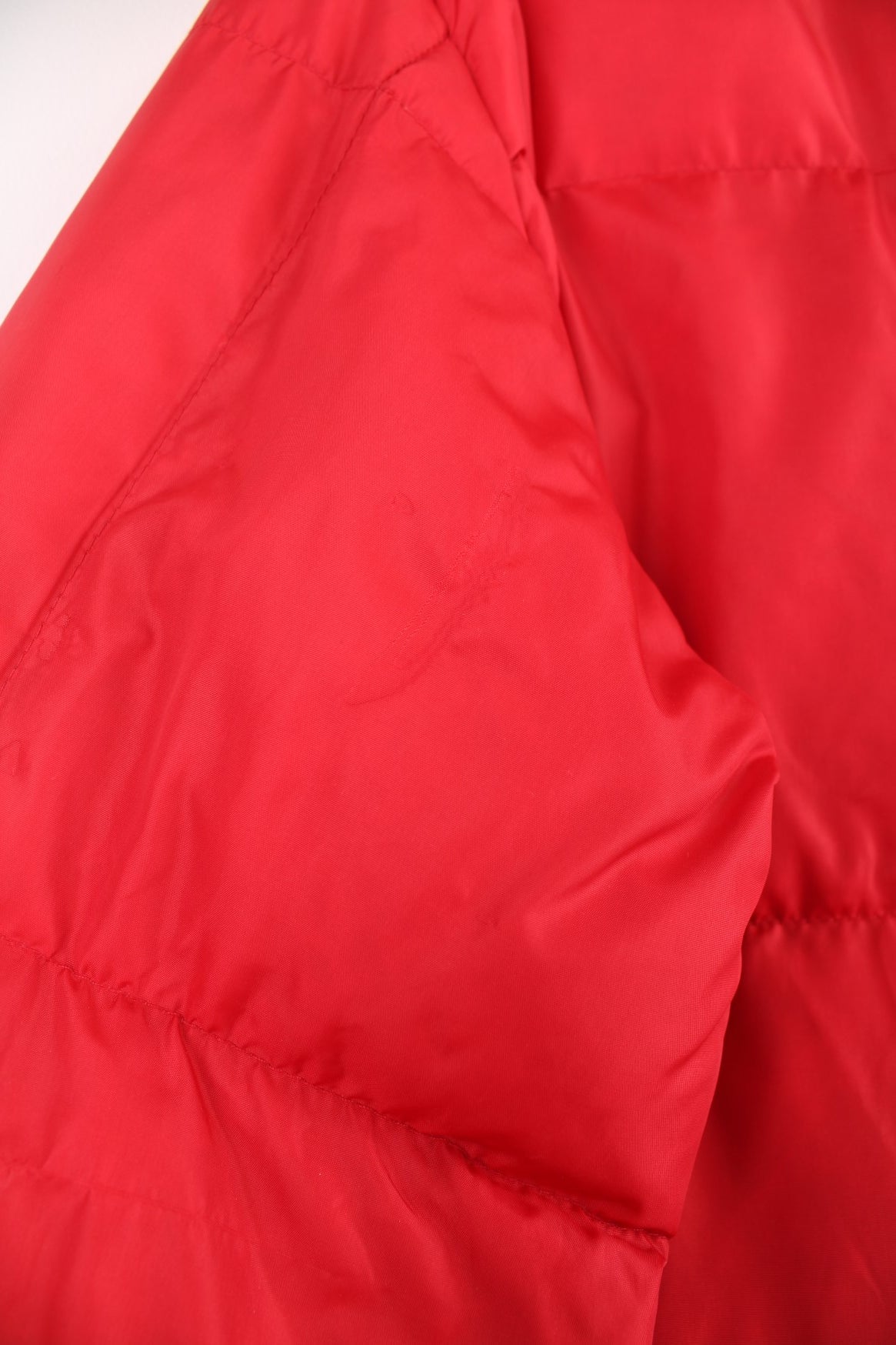 Red Bauer Down hooded puffer jacket with two pockets and zip closure. 