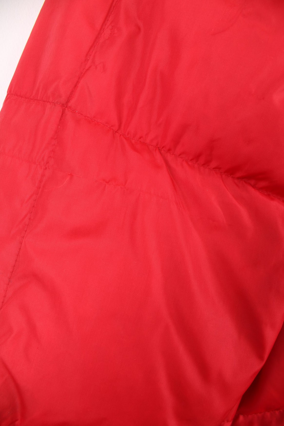 Red Bauer Down hooded puffer jacket with two pockets and zip closure. 