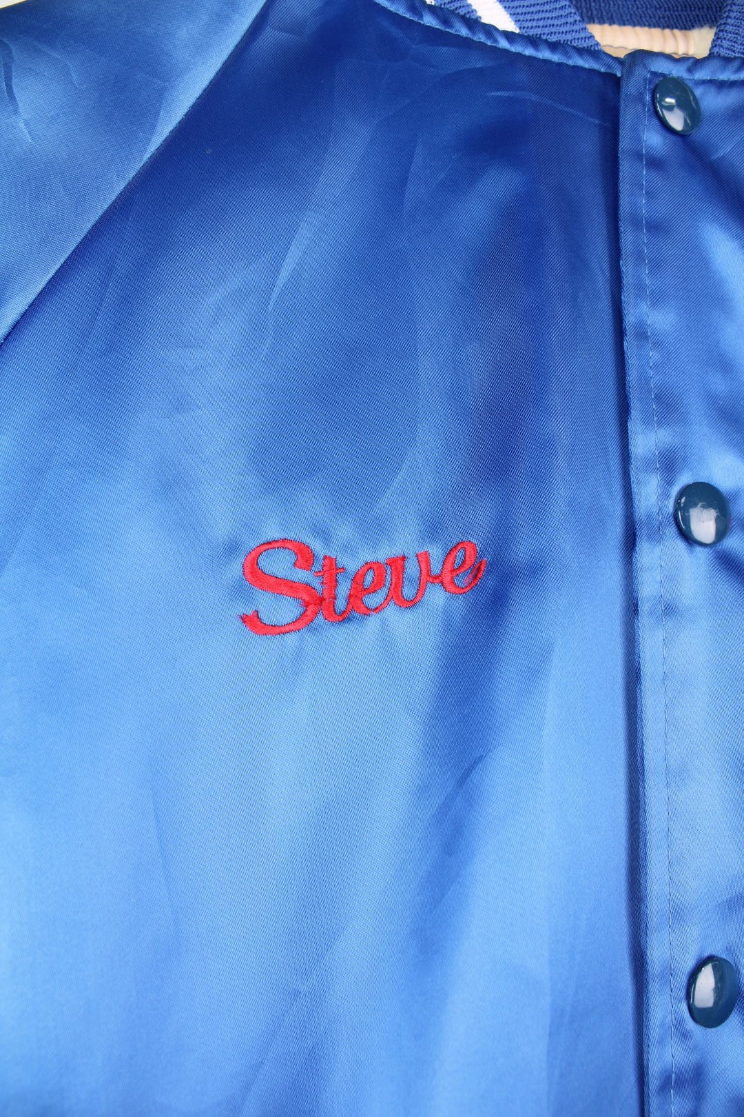 Blue 'Pepsi-Cola' personalised bomber jacket with white striped accents around the collar and cuffs. Snap closure, with the Pepsi-Cola logo embroidered on the chest and back. 