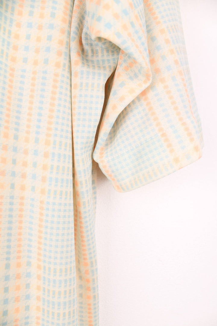 Cream, blue and orange tartan check shirt by Aristocrat Collection, with dagger collar, button closure, and a breast pocket. 