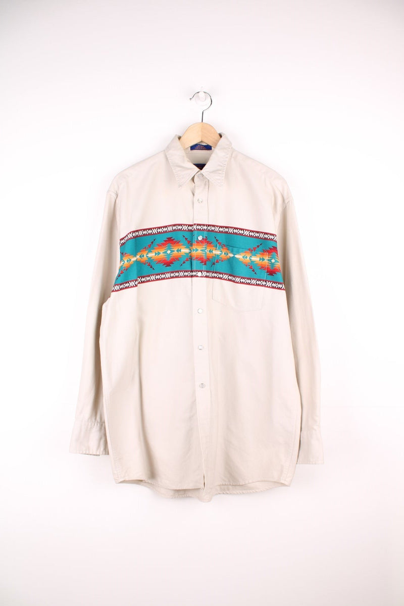 Vintage off-white Pendleton cotton shirt with red and turquoise Western detailing, snap closure, a breast pocket, and a dagger collar. 