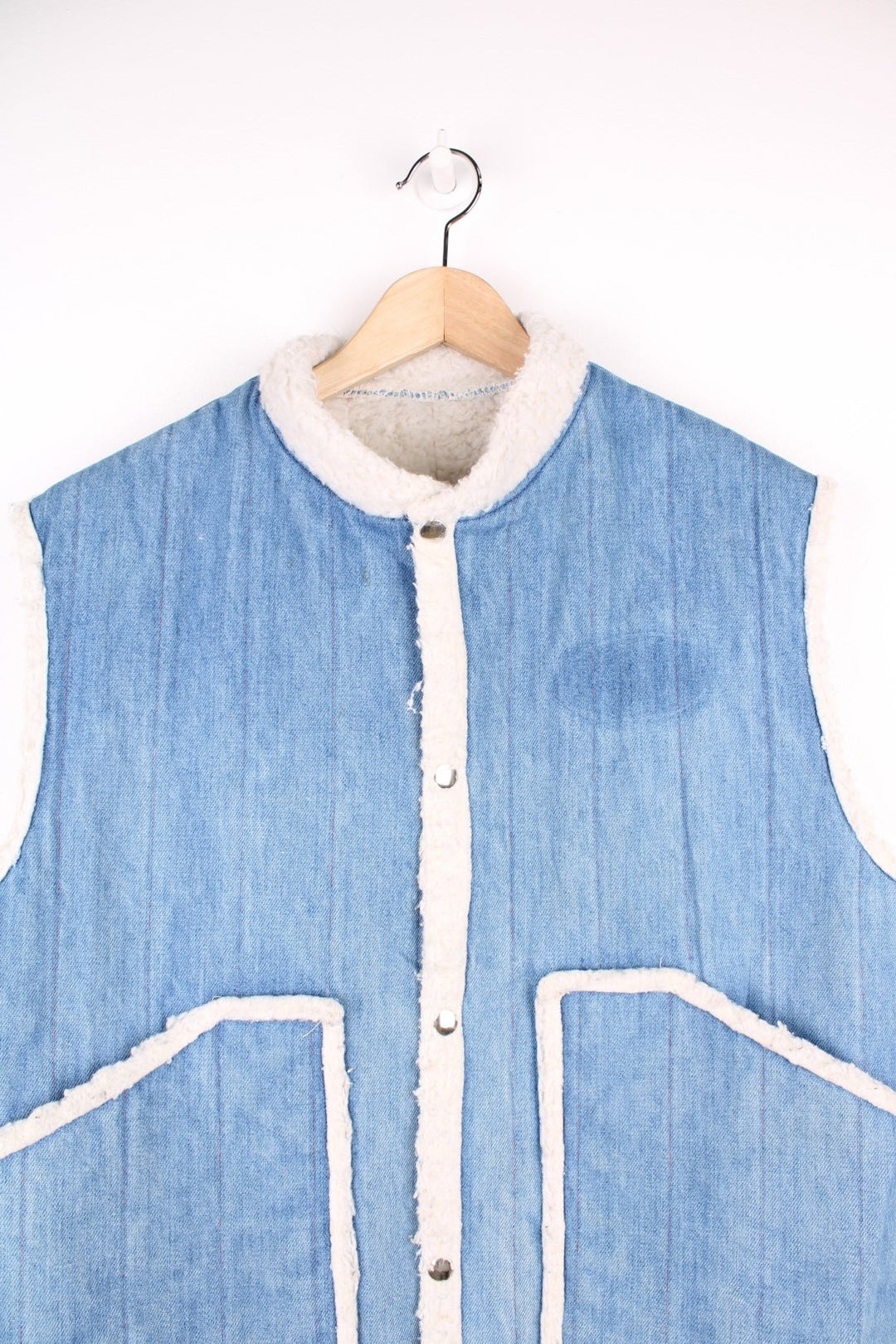 Vintage denim and shearling vest with front patch pockets and snap closure. 