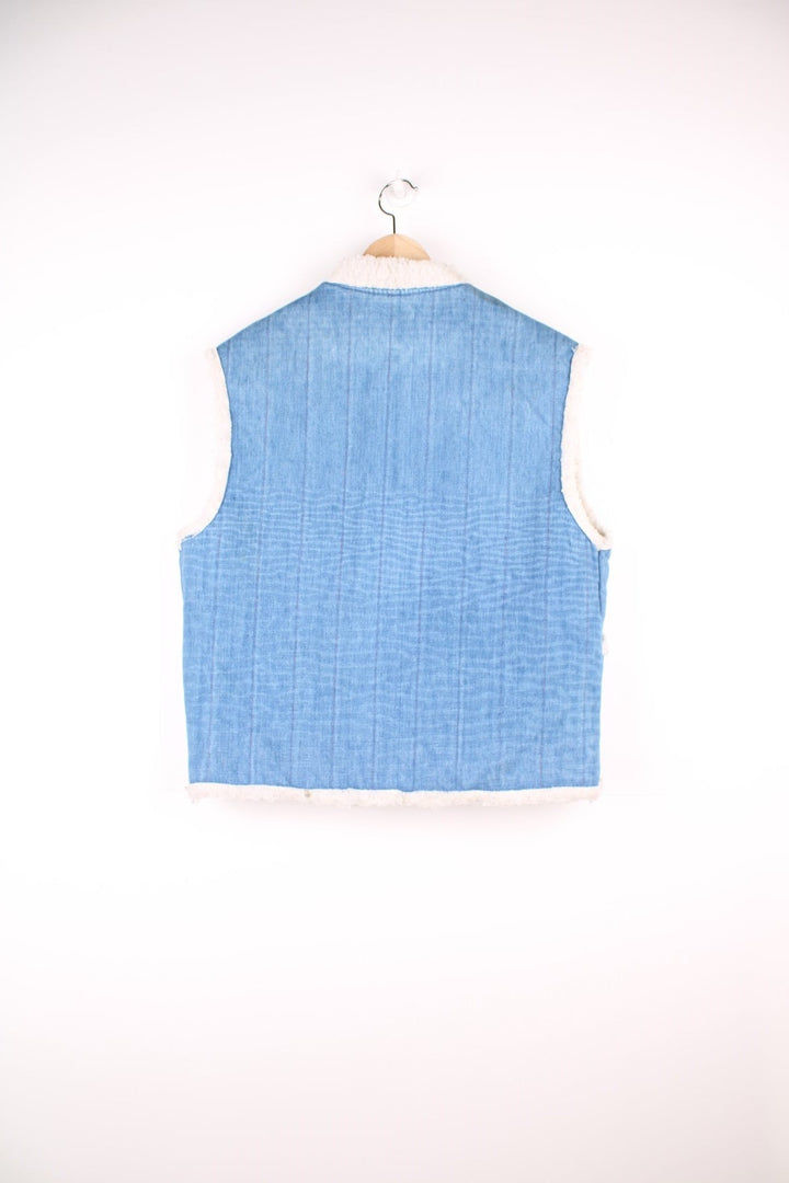 Vintage denim and shearling vest with front patch pockets and snap closure. 