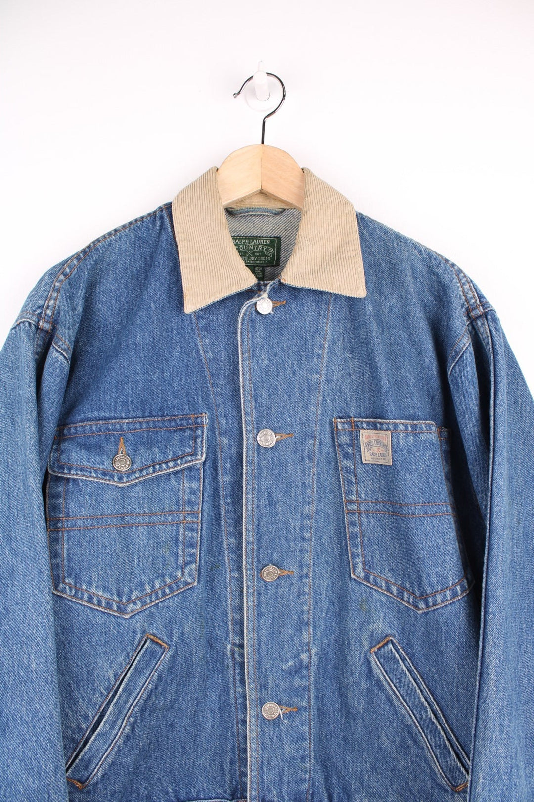 Ralph Lauren Country denim jacket with corduroy collar and applique. Four front pockets, with 'Polo Country' logos on the left breast pocket and the bottom back hem. 