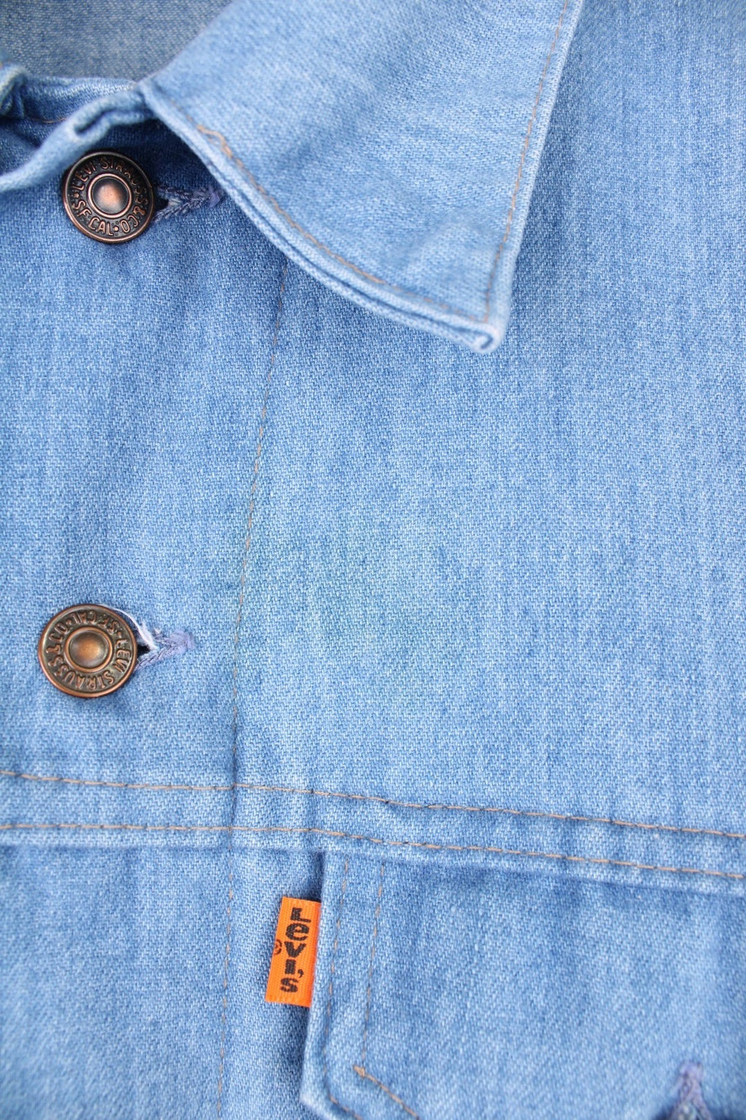 Vintage 1970s orange tab (lowercase 'e') Levi's denim overshirt/lightweight jacket with two flapped breast pockets, Levi's branded button closure, and waist adjusters. 