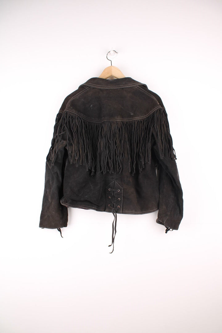 Western by Schott black suede fringe jacket with white contrast stitching, front patch pockets, button closure, a paisley lining, and lace-up detailing on the cuffs and back hem. 