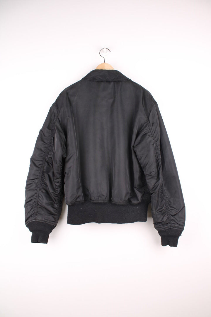 Alpha Industries black bomber jacket with zip closure, two front flap pockets and an arm pocket.