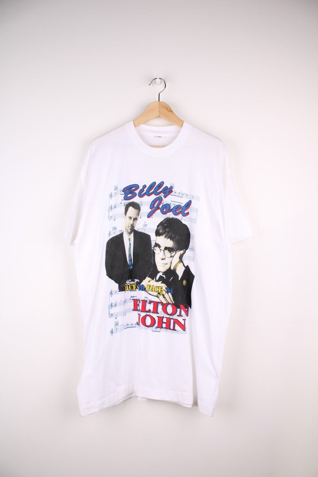 Vintage 1994 Billy Joel & Elton John Face to Face Tour T-Shirt in a white colourway with a graphic print of them on the front and on the back all the tour dates and graphic printed.