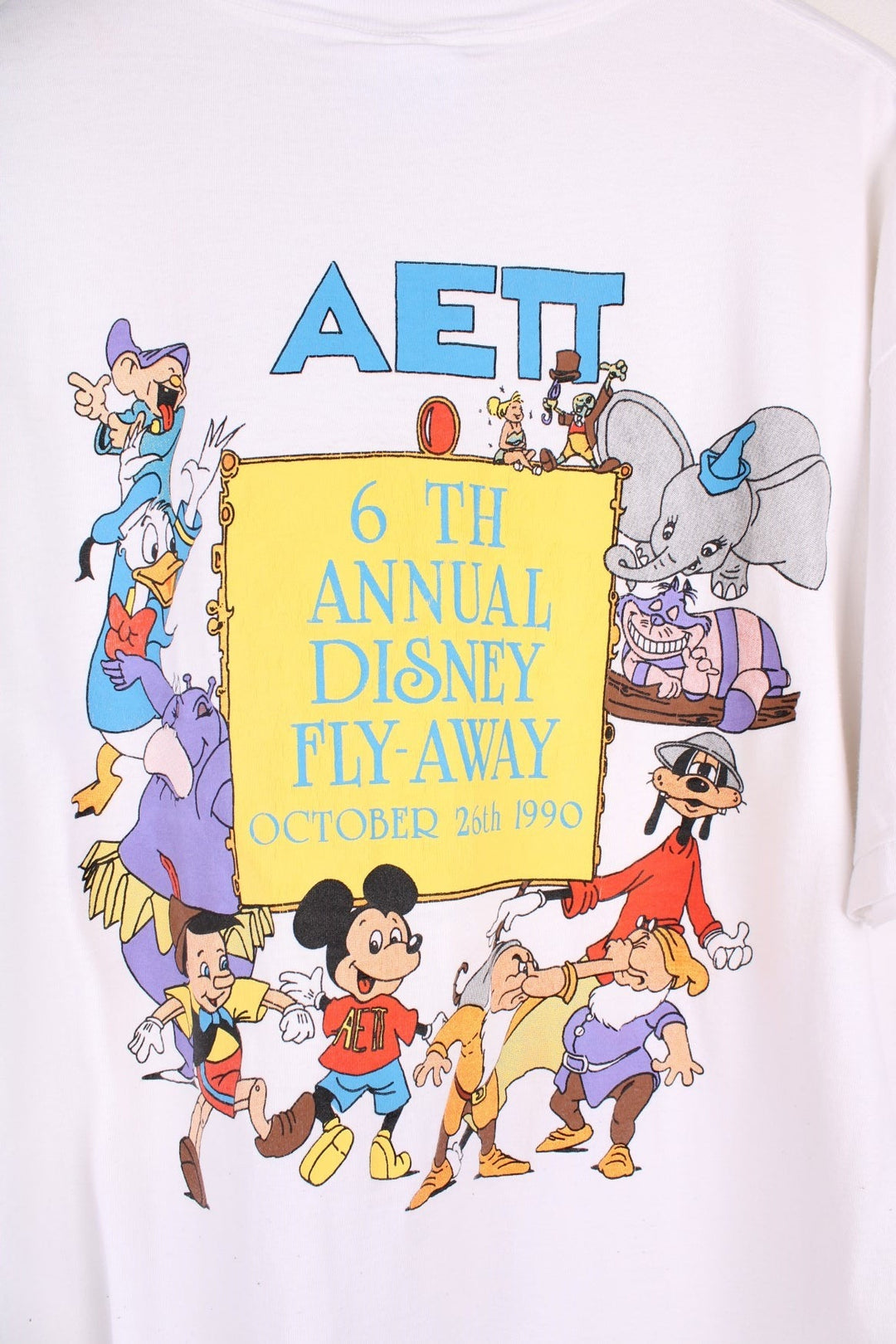 1990  Annual Fly-Away T-Shirt in a  colourway with the logo printed on the chest and on the back a big graphic printed with all the characters and spell out.