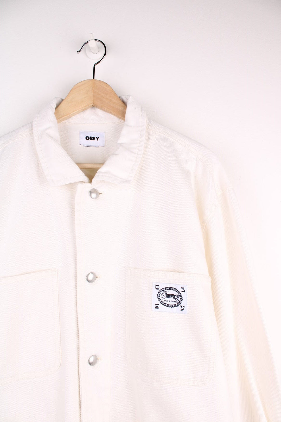  Obey Chore Jacket in a  colourway. Buttons up and has multiple pockets with the logo embroidered on the front.