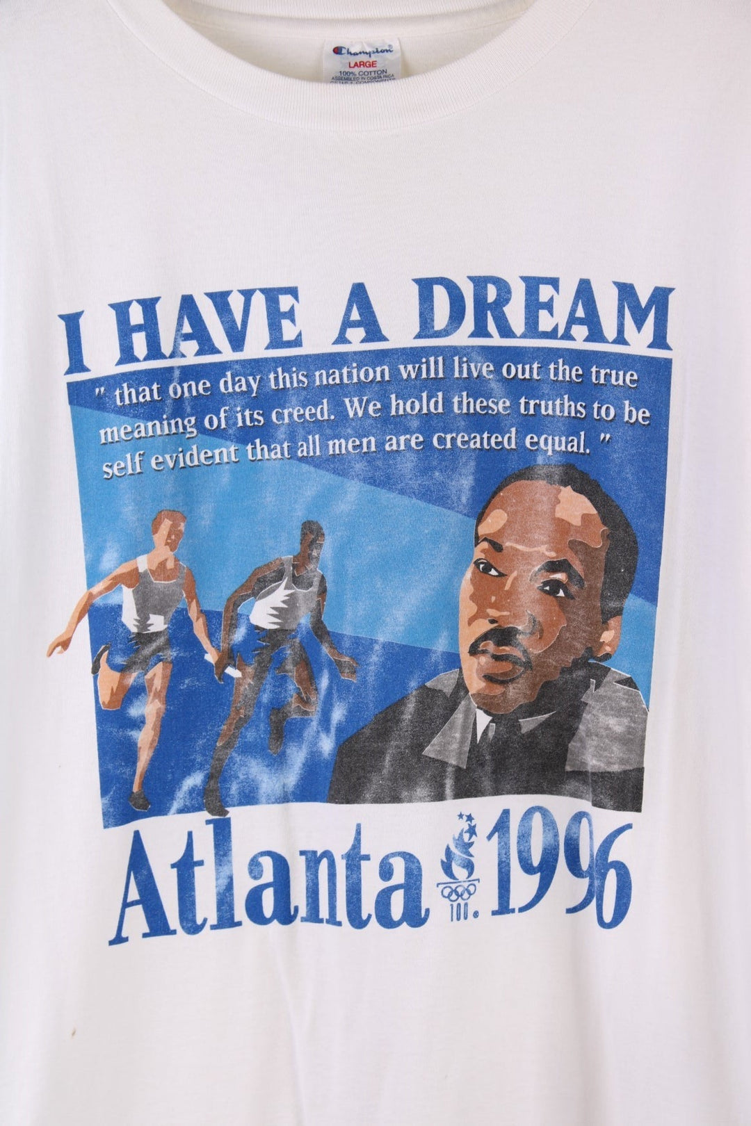  1996 Atlanta Olympics Martin Luther King Jr T-Shirt in a  colourway with the 'I Have a Dream' quote printed on the front alongside a graphic print of runners and Martin Luther King Jr.