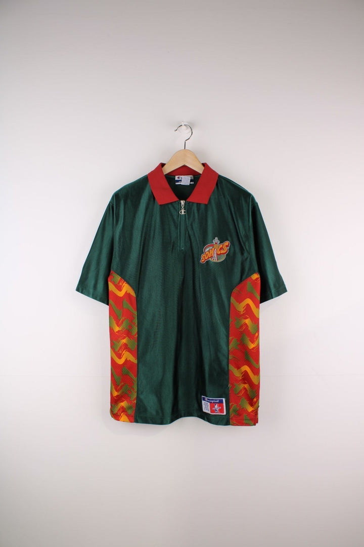 Seattle Supersonics NBA Polo Warm Up Champion Jersey in a green and red colourway with patterned stripes going down the sides, features quarter zip and has the team logo embroidered on the front and the spell out on the back.