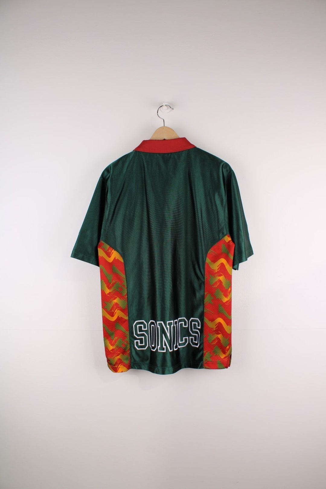 Seattle Supersonics  Polo Warm Up Champion Jersey in a  and red colourway with patterned stripes going down the sides, features quarter zip and has the team logo embroidered on the front and the spell out on the back.