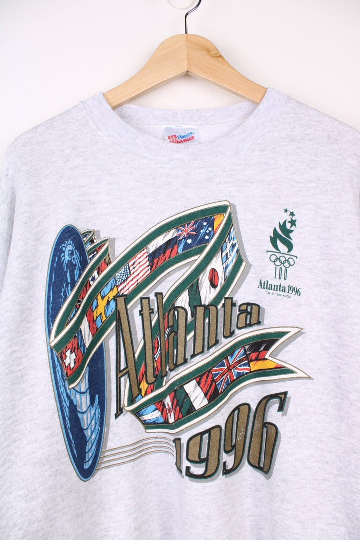  1996 Atlanta Olympics Sweatshirt in a  colourway with the spell out logo and graphic printed on the front.