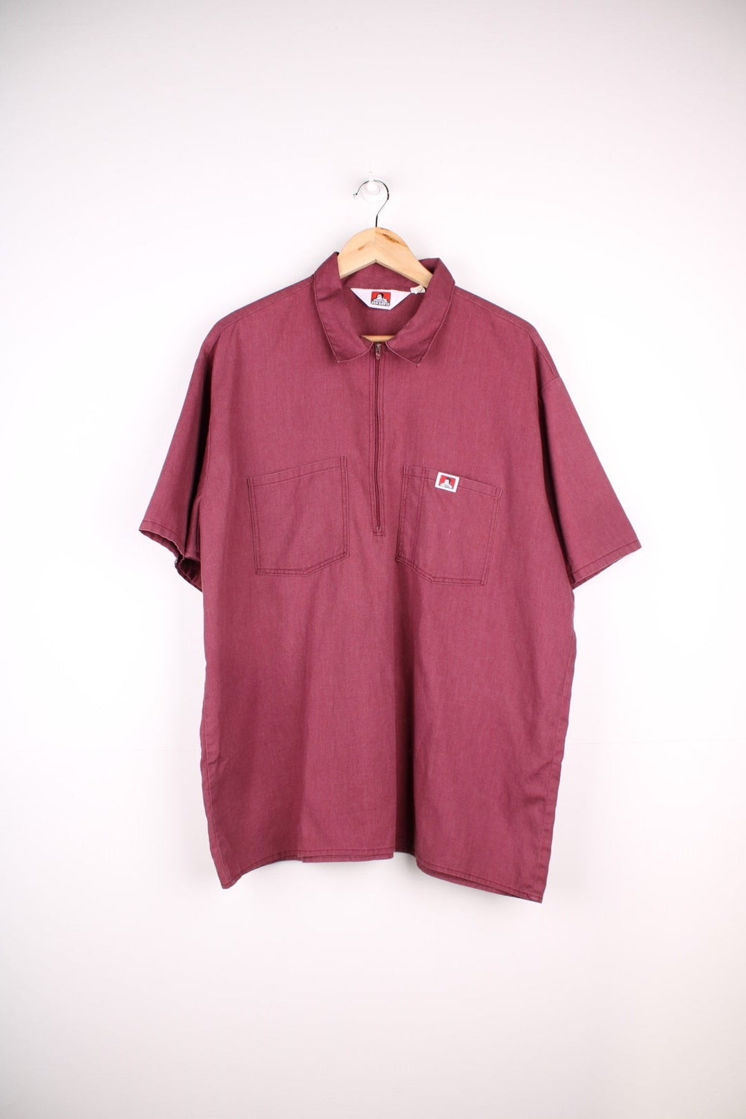 Ben Davis Work Wear Shirt in a burgundy red colourway, zip up half way, has double chest pockets with the logo embroidered on.