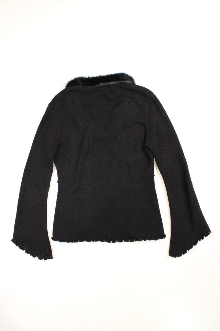  jumper by Escala in  with ruffle details, lettuce hems and cuffs, fluted sleeves, and a fluffy collar.