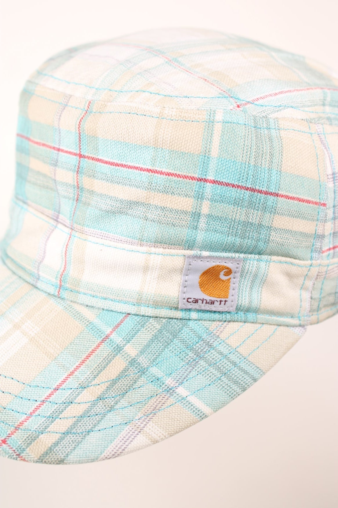 Carhartt El Paso Cap in a white, blue and red plaid colourway with the logo embroidered on the front and back, and has a adjustable velcro strap. 