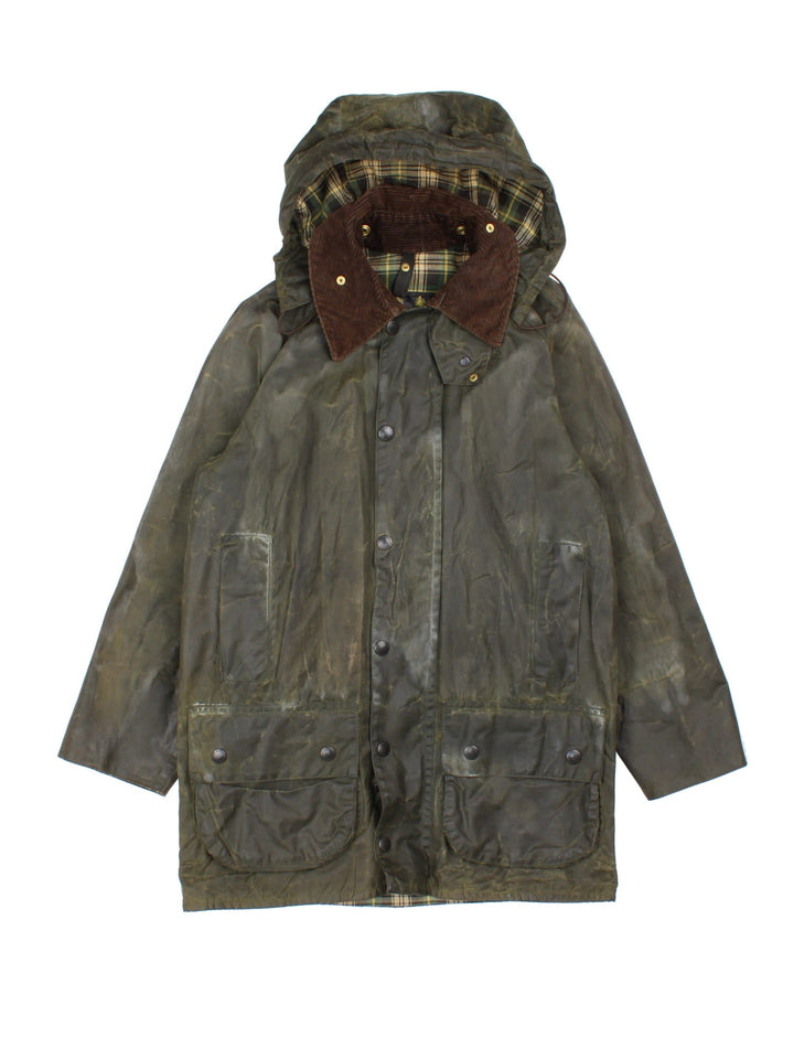 Barbour Beaufort Hooded Wax Jacket in a green colourway, zips and buttons up, has multiple pockets, detachable hood, and has a brown corduroy collar.