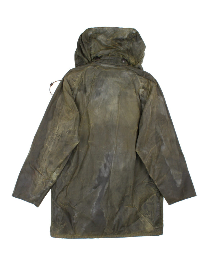 Barbour Beaufort Hooded Wax Jacket in a green colourway, zips and buttons up, has multiple pockets, detachable hood, and has a brown corduroy collar.