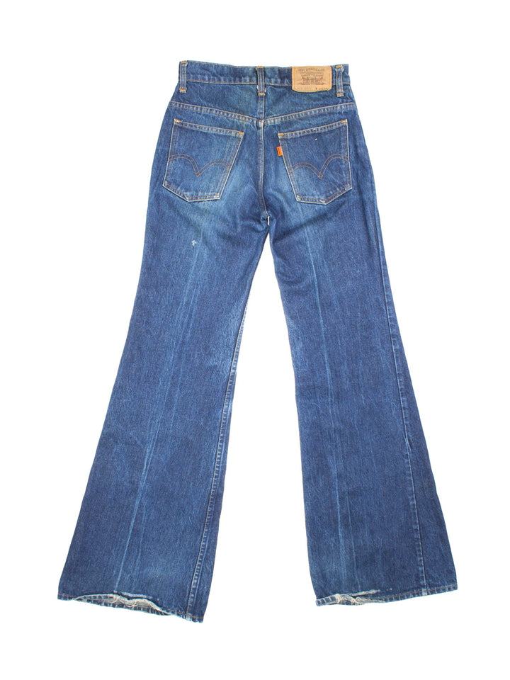 Levi Strauss flared jeans in blue with four pockets, zip and button closure, and a logo patch on the back.