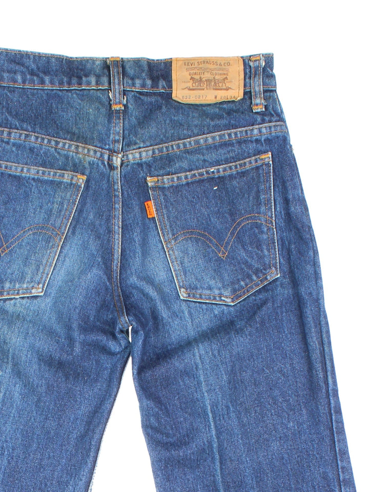 Levi Strauss flared jeans in blue with four pockets, zip and button closure, and a logo patch on the back.