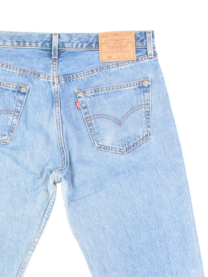 Levi Strauss jeans in a light blue wash with four pockets, zip and button closure, and a logo patch on the back.