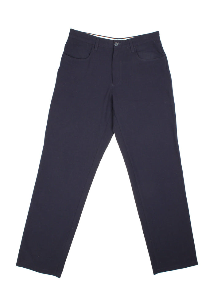 Armani trousers in black with four pockets, zip and button closure, and a small logo tab on the back.