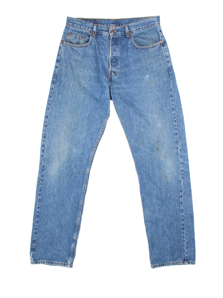 Levi Strauss 501 jeans in blue colourway with button up fly, straight leg and leather logo patch on the back.