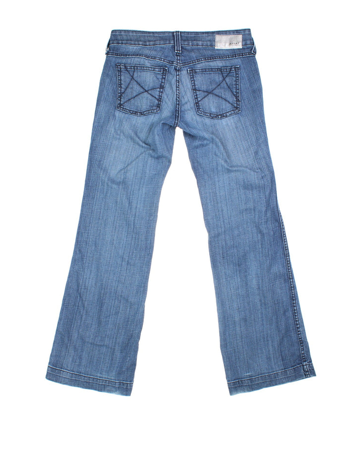 Vintage Y2K Ariat Flared Jeans in blue colourway. Low waisted fit with zip up fly, flared leg and leather logo patch on the back.