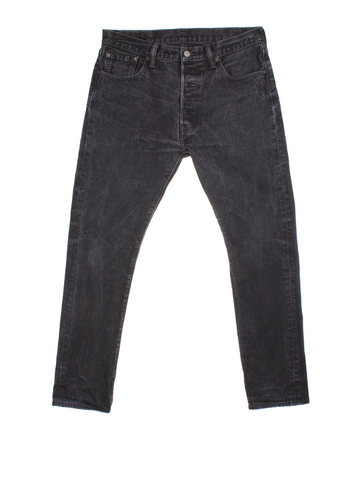 Levi Strauss 501 jeans in black colourway with button up fly, straight leg and leather logo patch on the back.