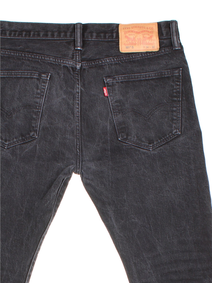 Levi Strauss 501 jeans in black colourway with button up fly, straight leg and leather logo patch on the back.