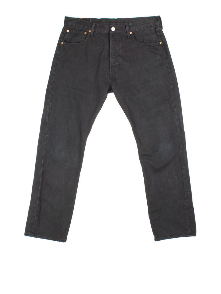 Levi Strauss 501 jeans in black colourway with button up fly, straight leg and leather logo patch on the back.