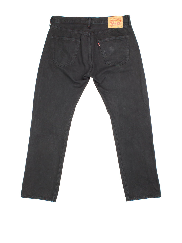 Levi Strauss 501 jeans in black colourway with button up fly, straight leg and leather logo patch on the back.