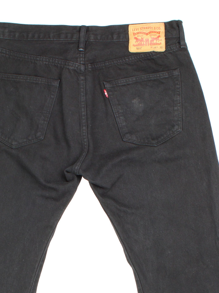 Levi Strauss 501 jeans in black colourway with button up fly, straight leg and leather logo patch on the back.