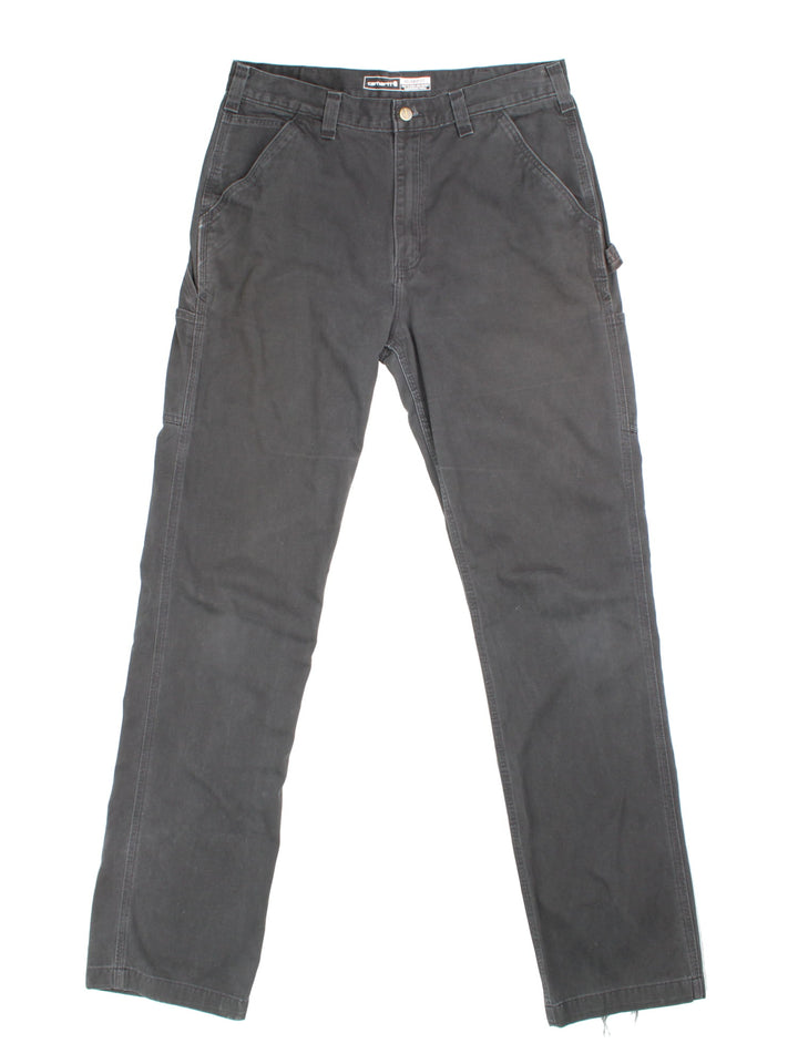 Carhartt Trousers in black colourway with multiple pockets and the logo embroidered on the back.