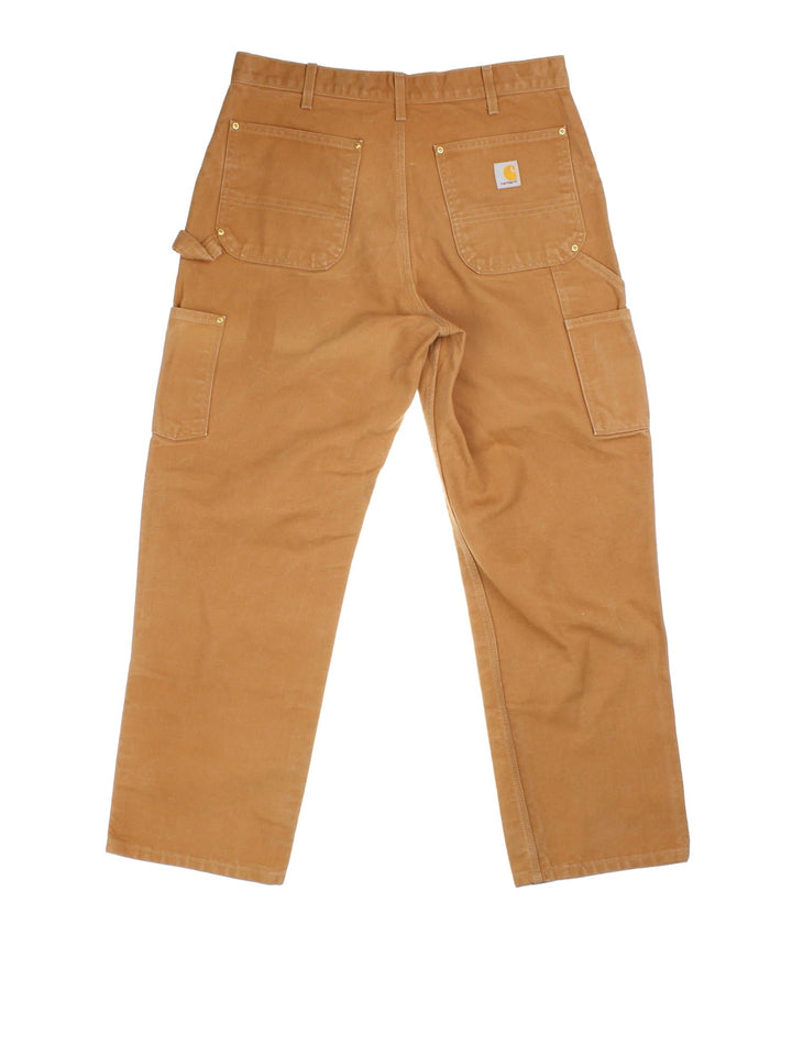 Carhartt Double Knee Jeans in tan colourway with multiple pockets and the logo embroidered on the back.